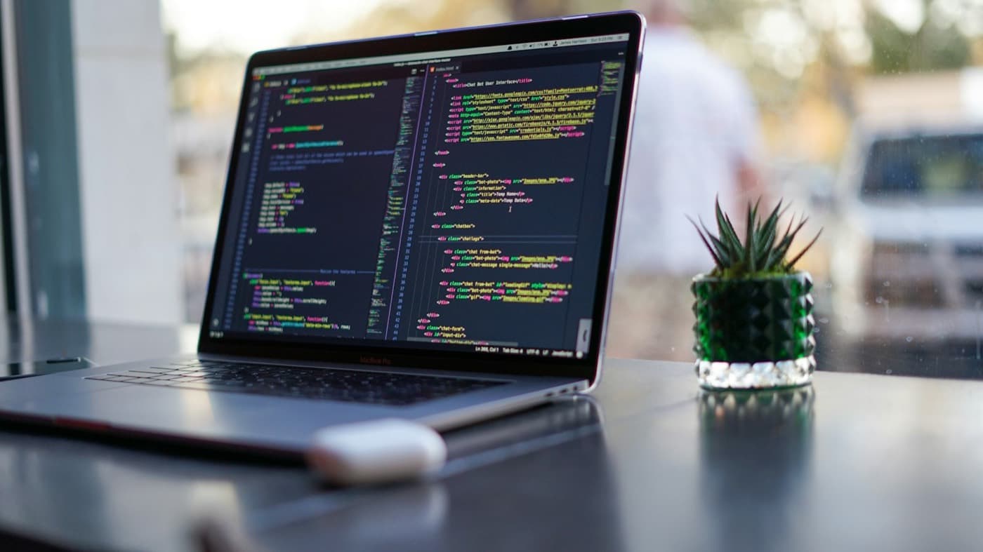Laptop with code open at a desk